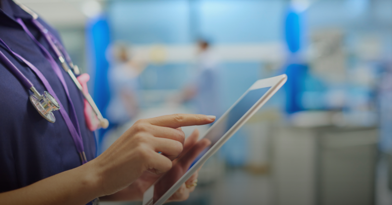 Medical staff holding a tablet