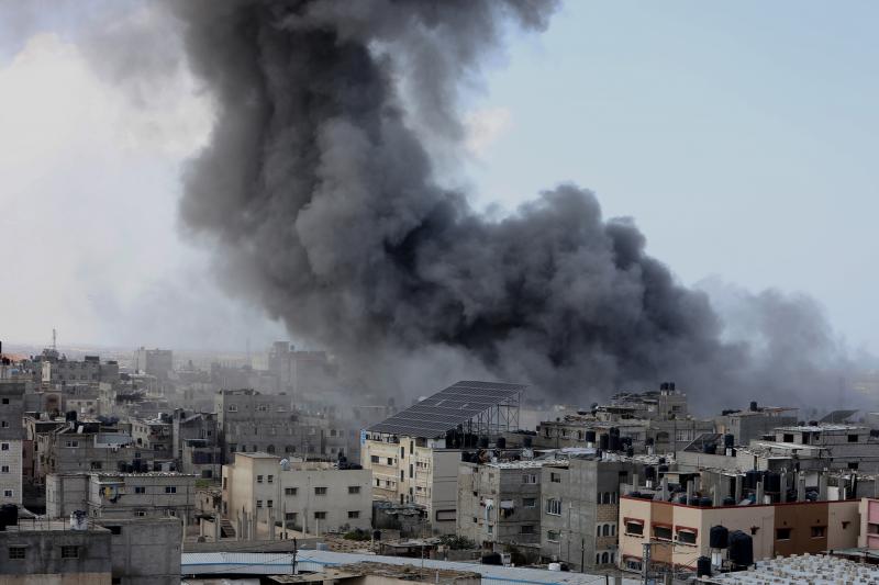 Smoke rises after Israeli air strikes near the border east of the city of Rafah in the southern Gaza Strip, on 12 October 2023.