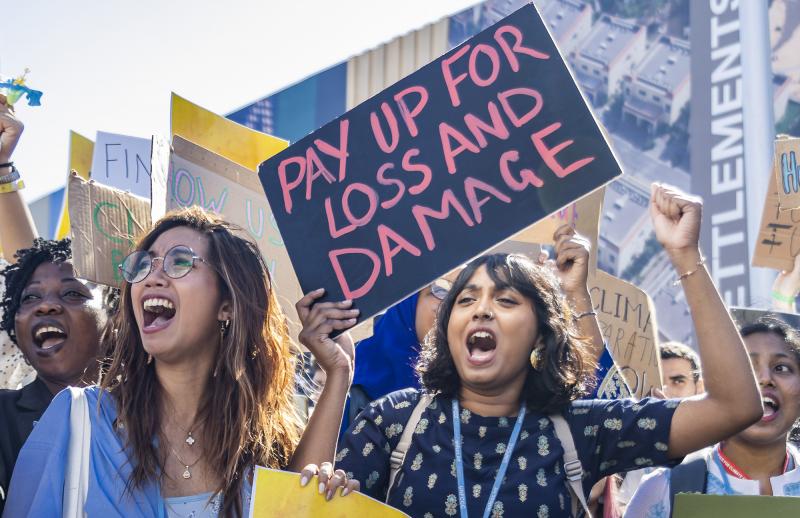 Activists with a Pay for Loss and Damage placard at COP27